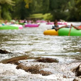 a group of people floating down a river