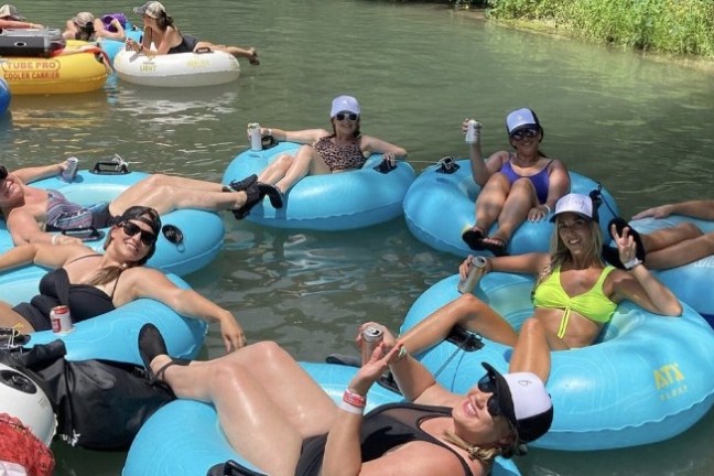 a group of people floating down a river