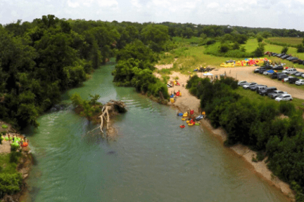 a boat traveling along a river next to a body of water