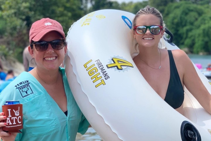 a woman posing with a tube by a river