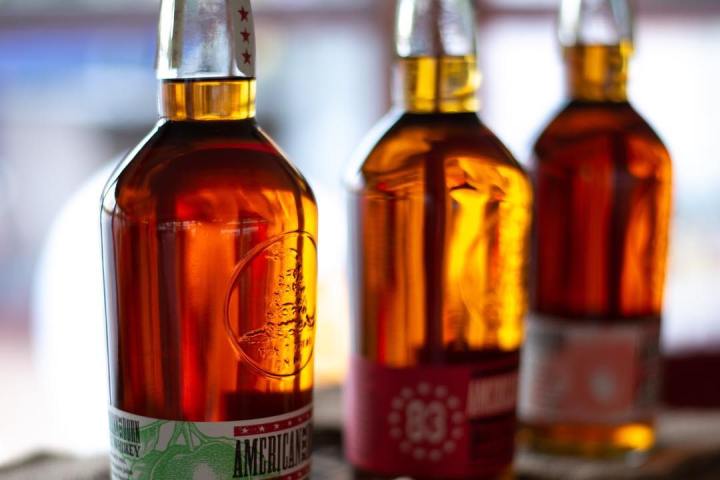 a close up of three bottles of whiskey