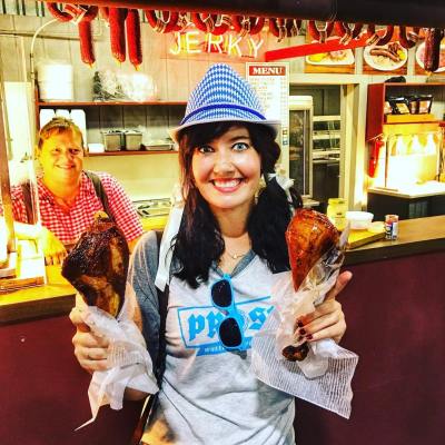 a woman holding two turkey legs