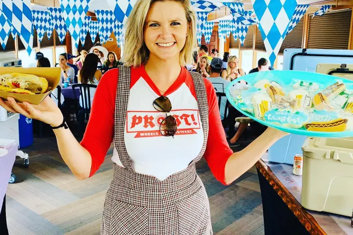 a woman posing for a picture with food in her hands